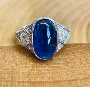 <br><h3>A cabochon and sapphire ring</h3><br>
An ornate and design, reminiscent of the art deco period.