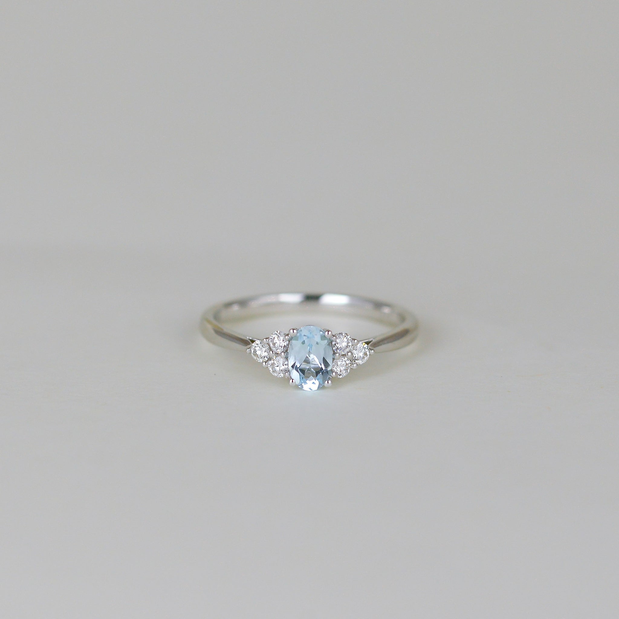 9ct White Gold 0.50ct Oval Blue Topaz and Diamond Cluster Ring