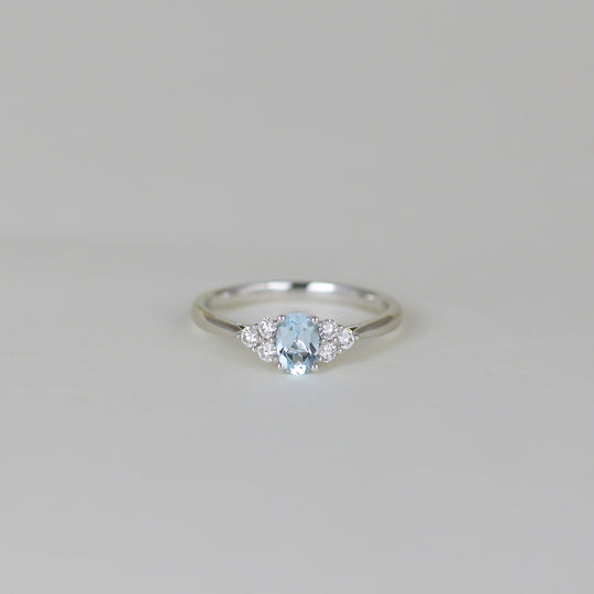 9ct White Gold 0.50ct Oval Blue Topaz and Diamond Cluster Ring