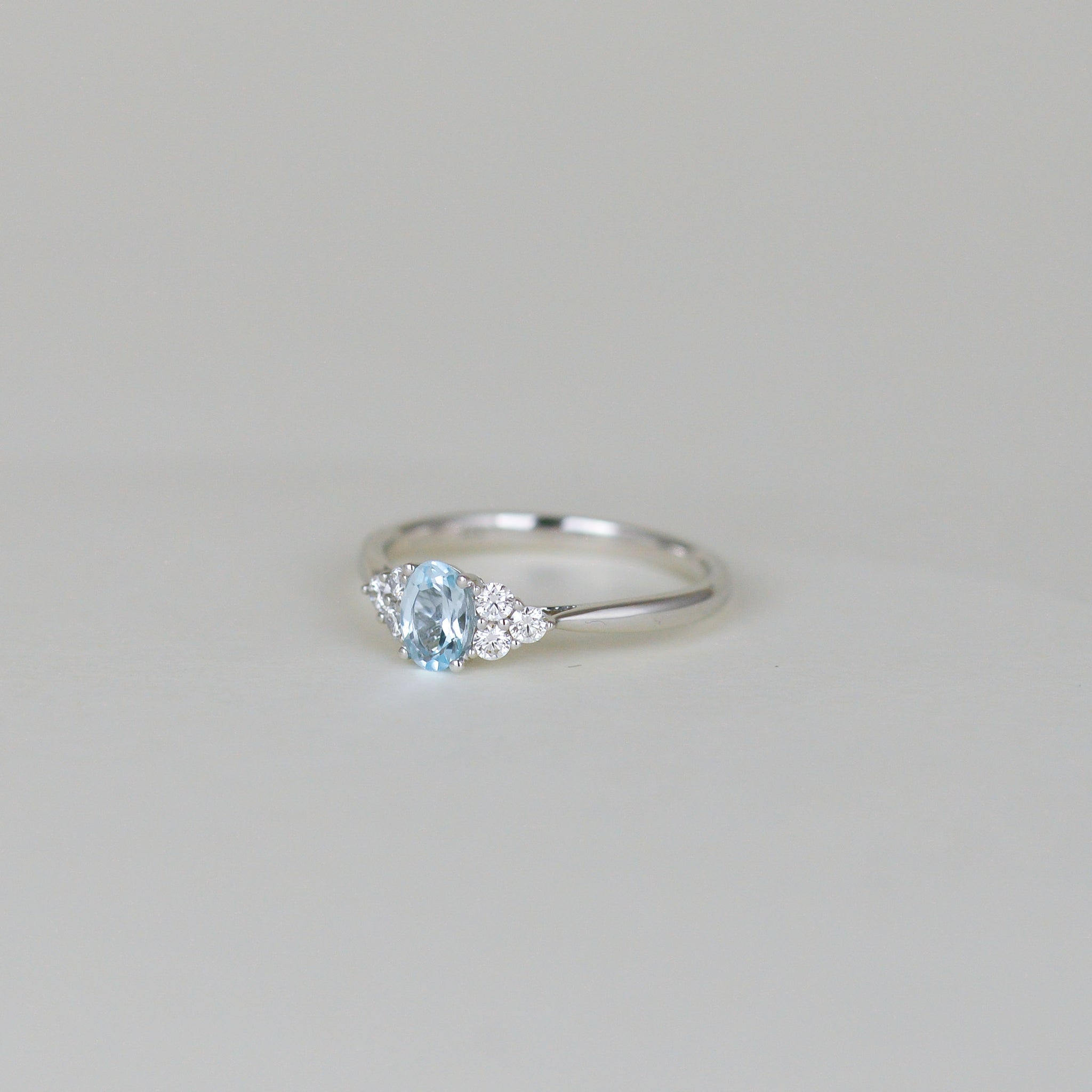 9ct White Gold 0.50ct Oval Blue Topaz and Diamond Cluster Ring
