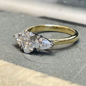 <br><h3>A stunning oval cut three stone</h3><br>
With dazzling pear cut diamonds either side