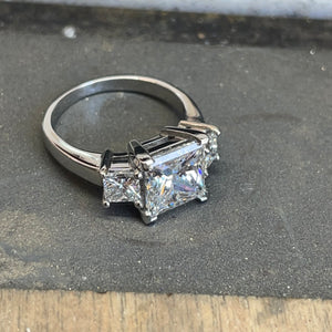 <br><h3>A princess cut three stone engagement ring</h3><br>
We remade the setting on this gorgeous three-stone engagement ring