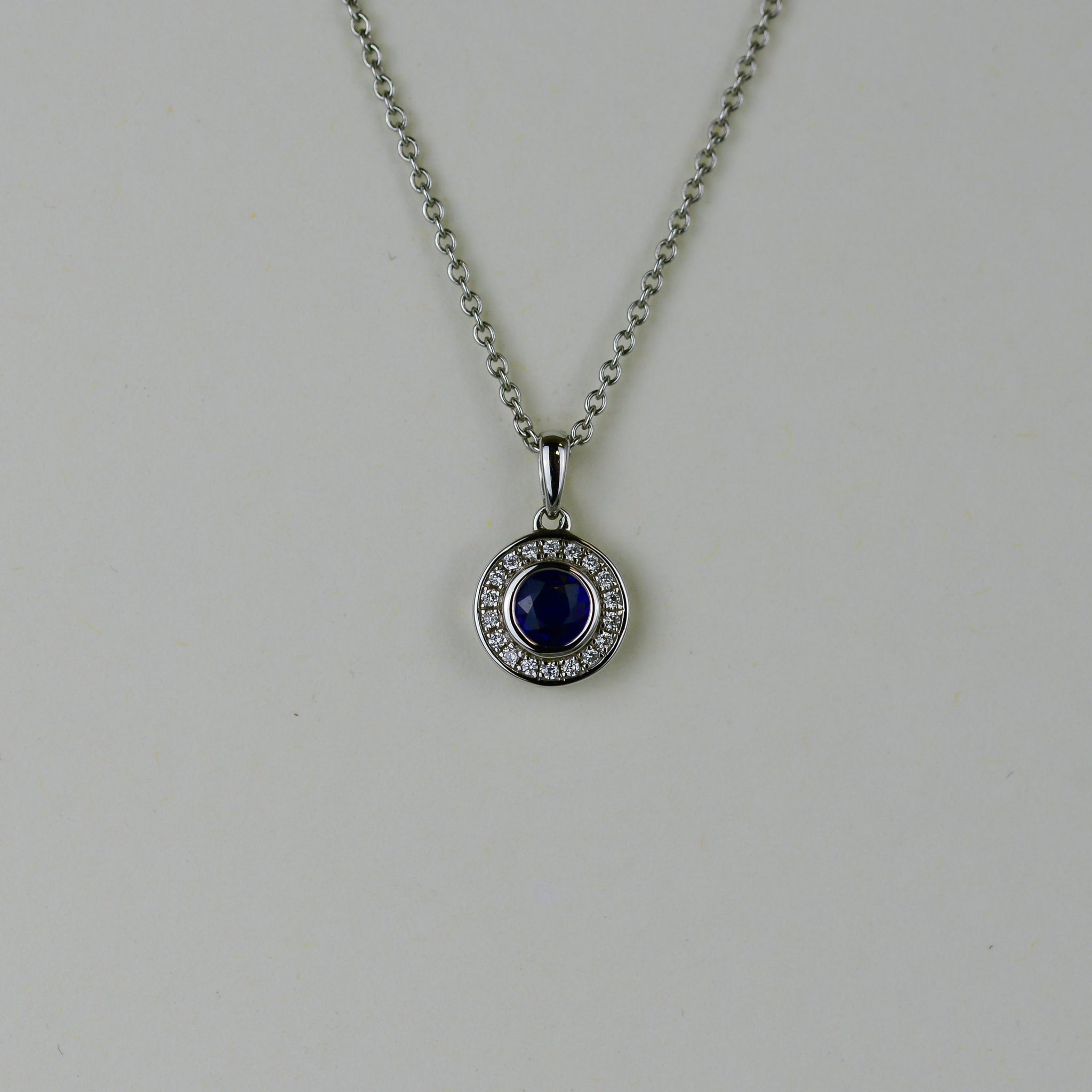 18ct White Gold 0.31ct Sapphire and Diamond Halo Pendant