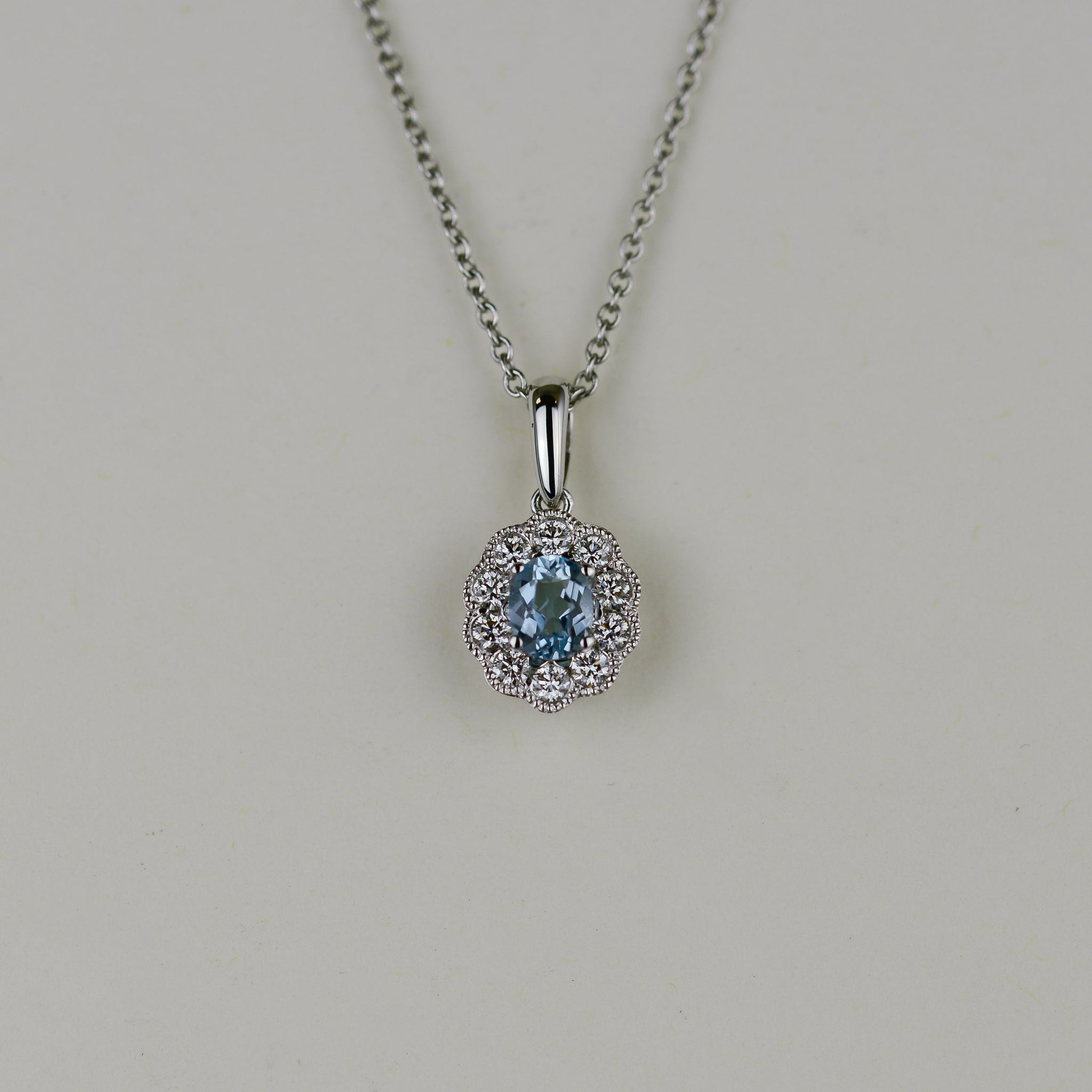 18ct White Gold 0.32ct Oval Aquamarine and Diamond Cluster Pendant