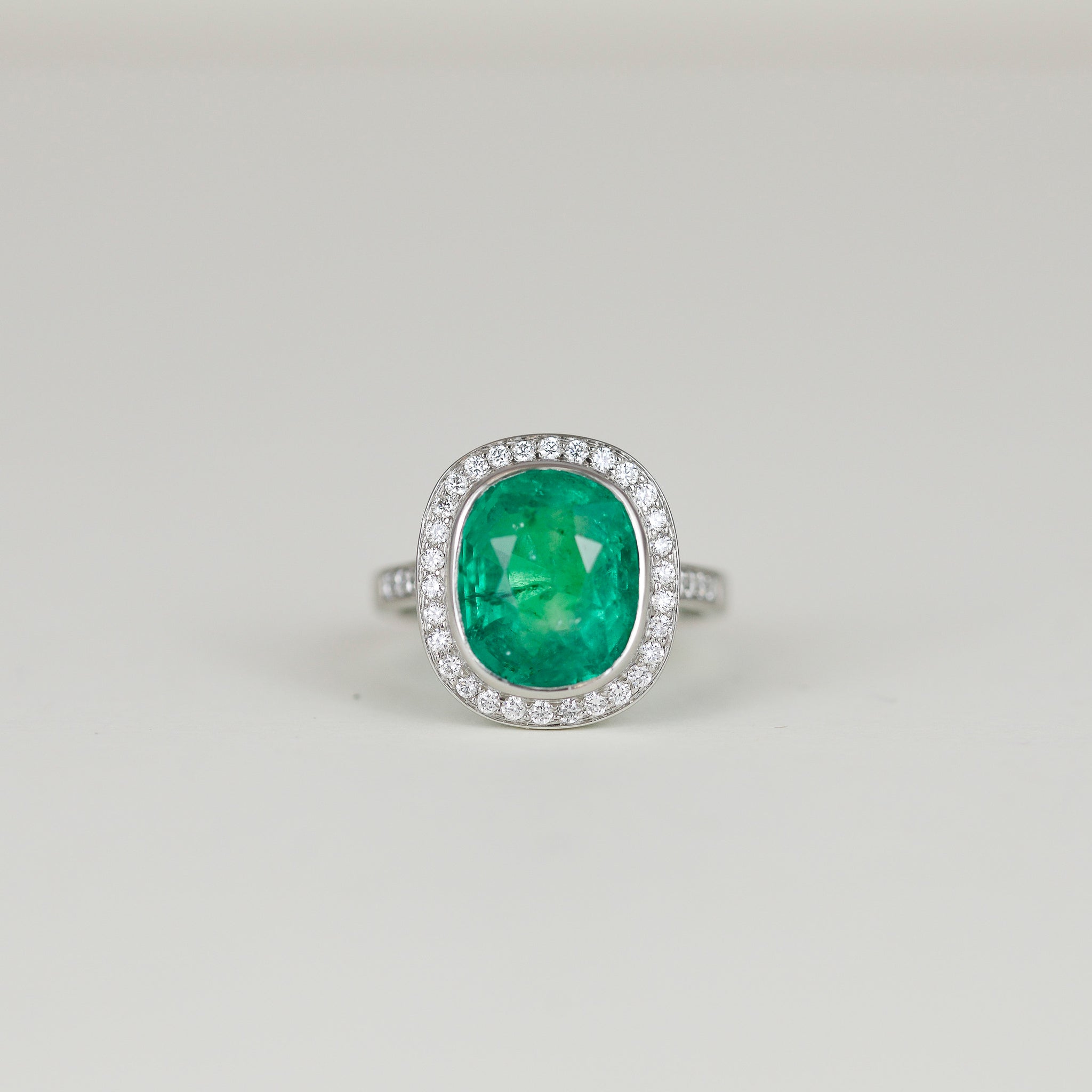 Platinum 7.08ct Emerald and Diamond Cluster Ring