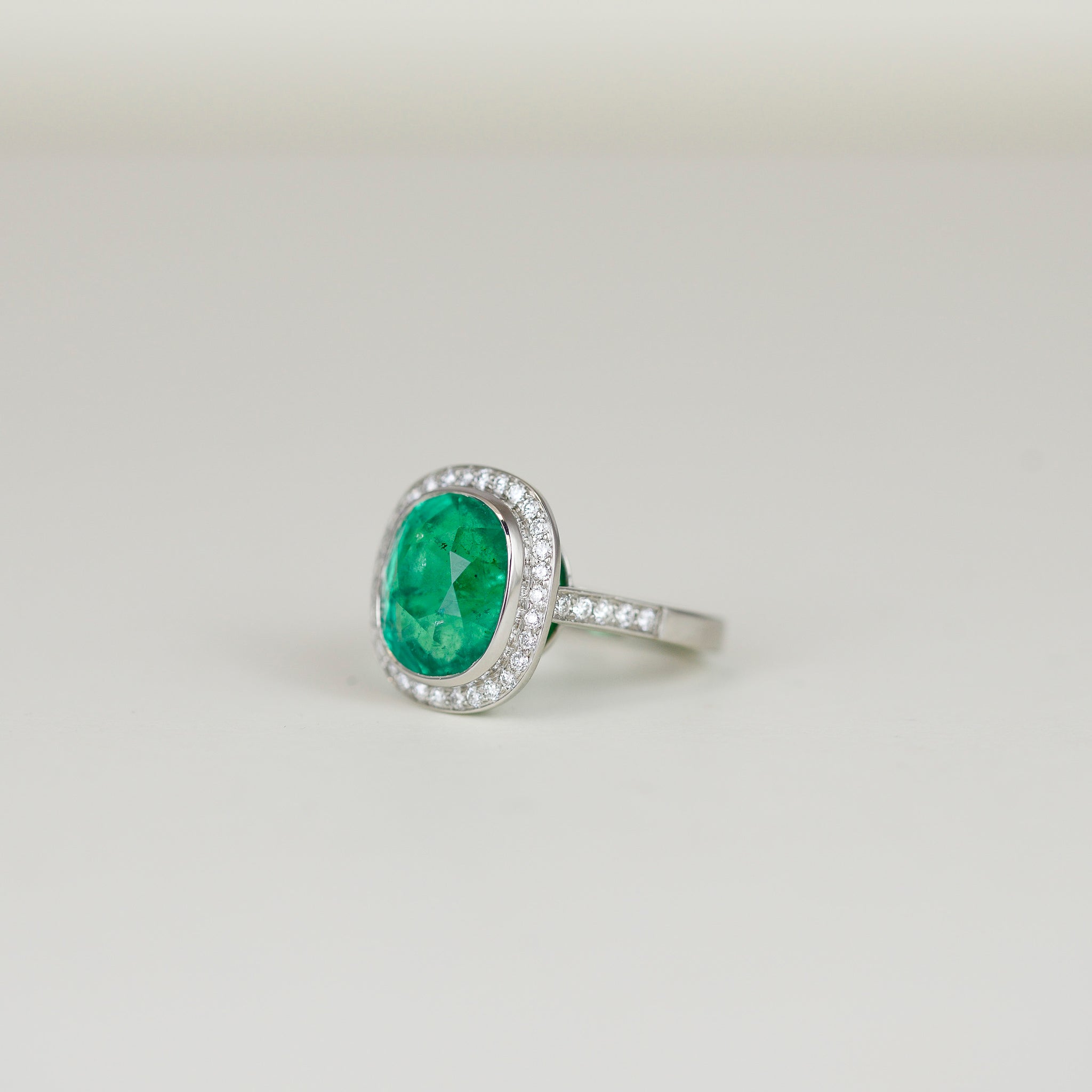 Platinum 7.08ct Emerald and Diamond Cluster Ring