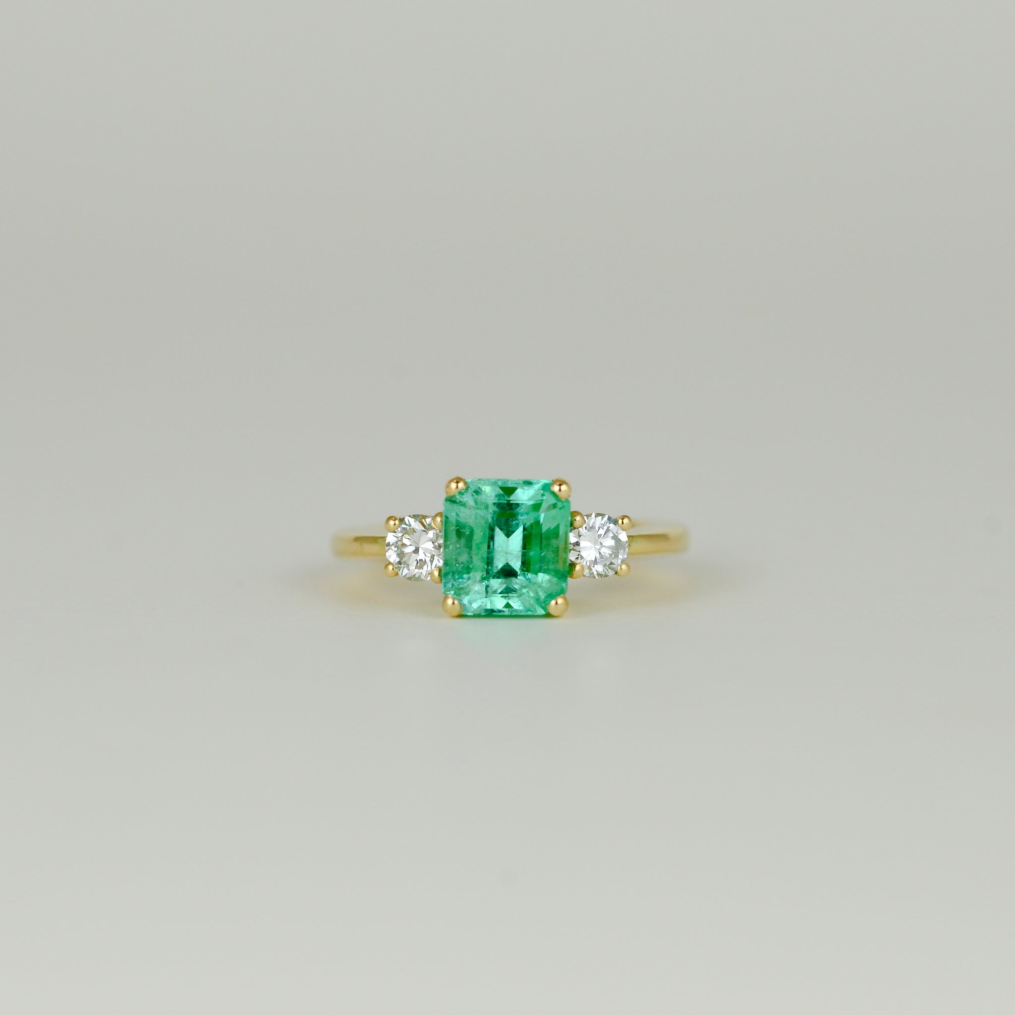 18ct Yellow Gold 2.26ct Emerald Cut Emerald and Diamond Three Stone Ring